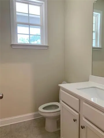 a bathroom with a toilet sink and window