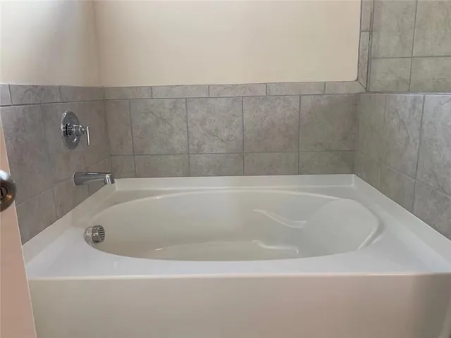 a white bath tub sitting in a bathroom