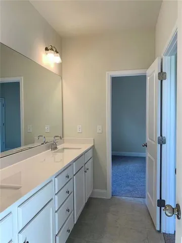 a spacious bathroom with a double vanity sink and a mirror