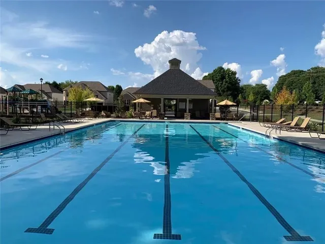 a view of a house with backyard porch and sitting area