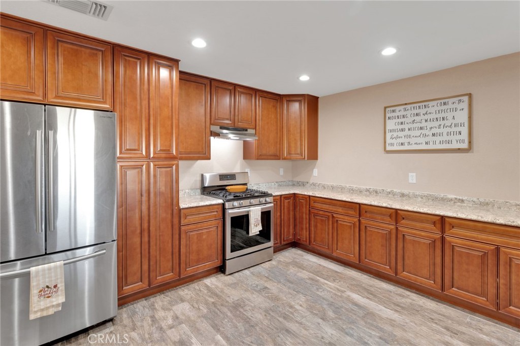 32461 Prairie Avenue Barstow, CA 92311 - Photo 12 of 46 a kitchen with stainless steel appliances granite countertop a refrigerator sink and stove