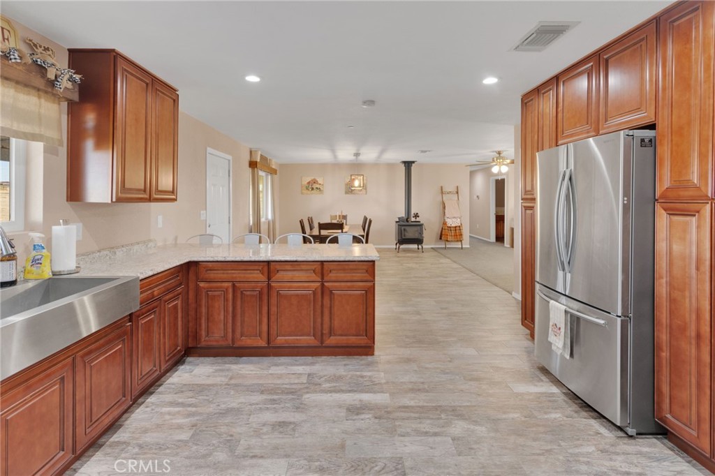 32461 Prairie Avenue Barstow, CA 92311 - Photo 13 of 46 a large kitchen with stainless steel appliances granite countertop a refrigerator and a sink