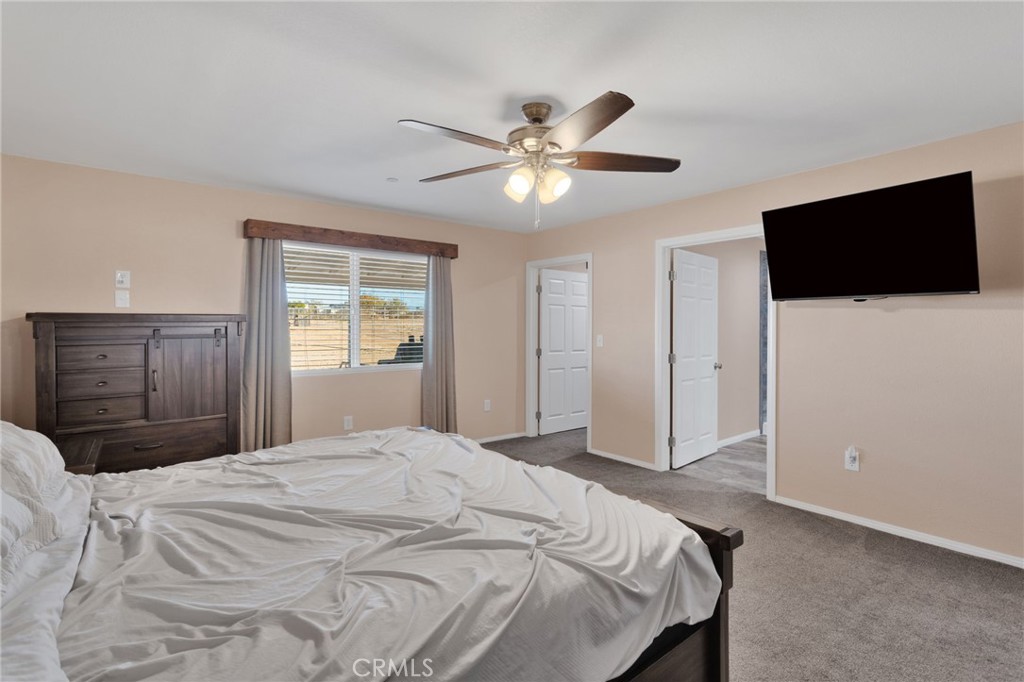 32461 Prairie Avenue Barstow, CA 92311 - Photo 16 of 46 a bedroom with a bed and a flat screen tv
