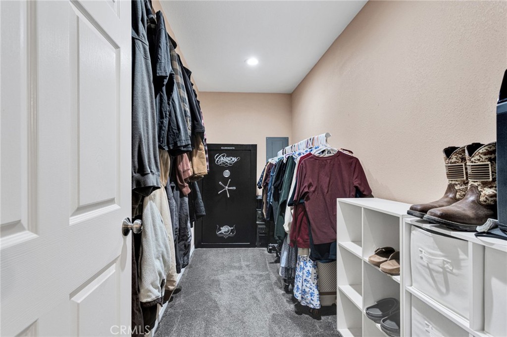 32461 Prairie Avenue Barstow, CA 92311 - Photo 18 of 46 a view of walk in closet with clothes and shoes
