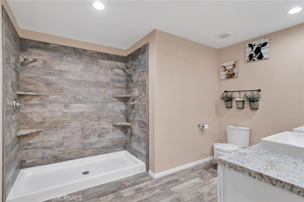 32461 Prairie Avenue Barstow, CA 92311 - Photo 19 of 46 a bathroom with a granite countertop sink a mirror and shower