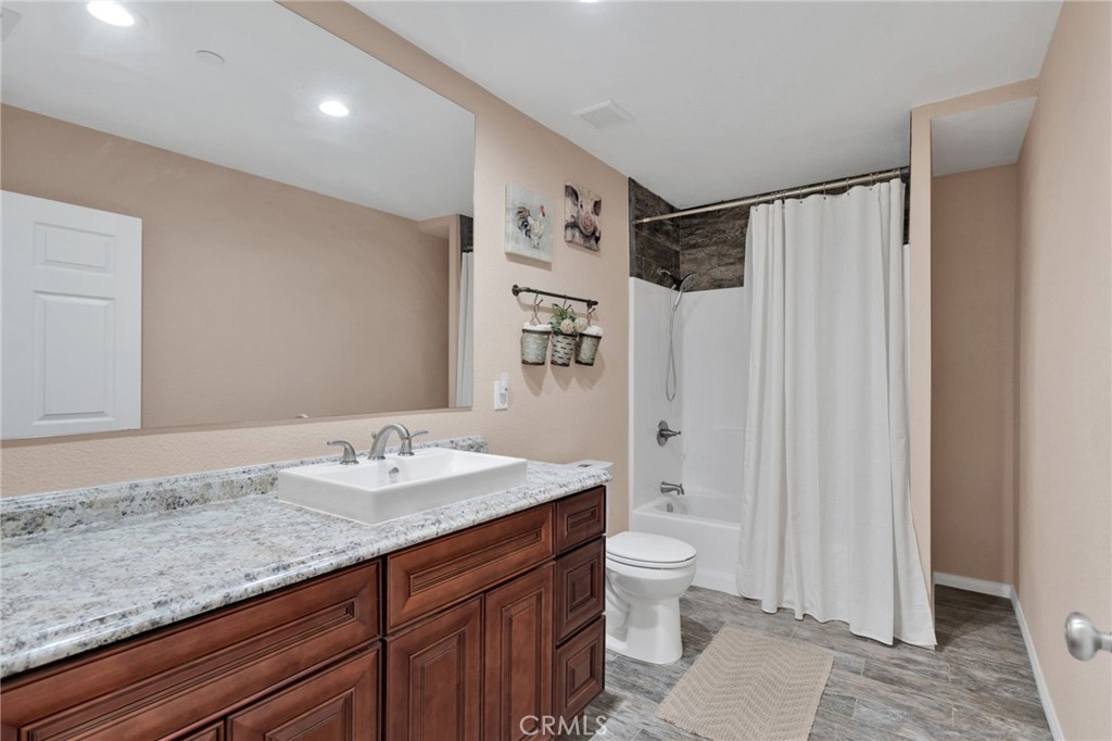 32461 Prairie Avenue Barstow, CA 92311 - Photo 23 of 46 a bathroom with a granite countertop sink toilet and shower