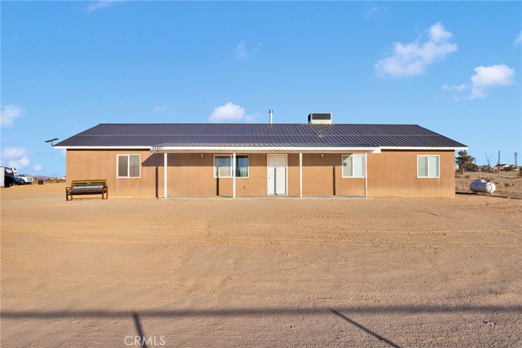 32461 Prairie Avenue Barstow, CA 92311 - Photo 3 of 46 a front view of a house with a yard and garage