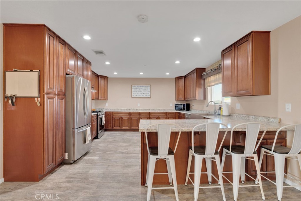 32461 Prairie Avenue Barstow, CA 92311 - Photo 10 of 46 a large kitchen with a table and chairs