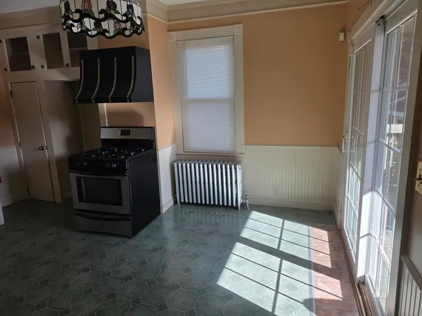 a kitchen with a refrigerator and a stove