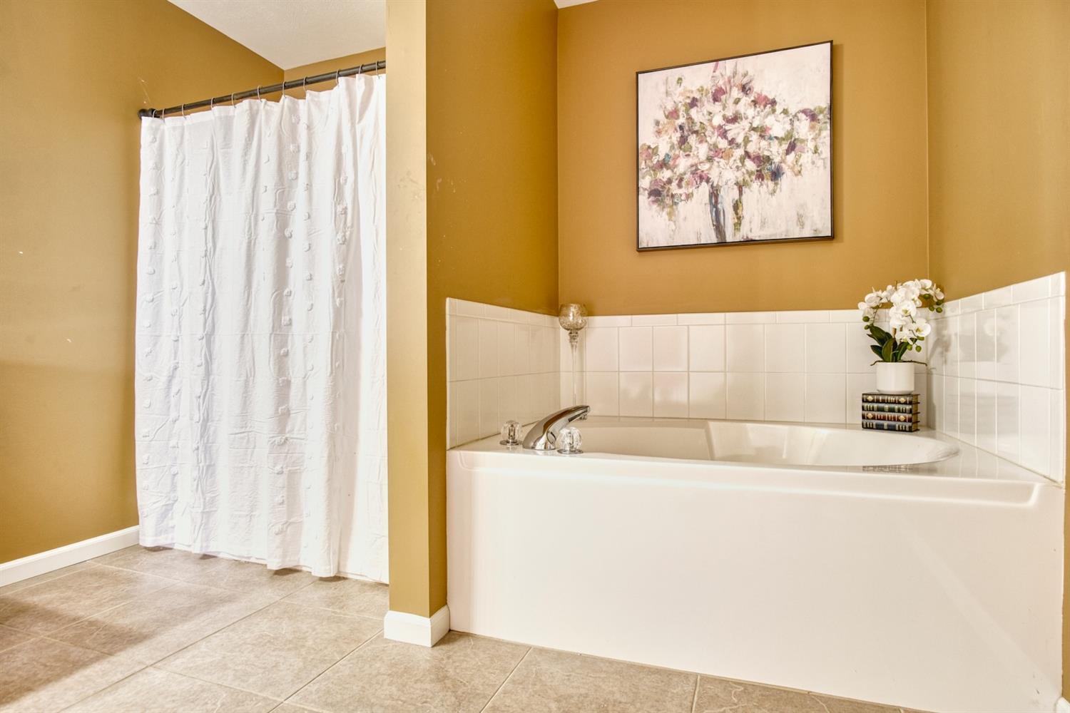 9512 Dewey Place Crown Point, IN 46307 - Photo 12 of 27 a bathroom with a bathtub and a shower