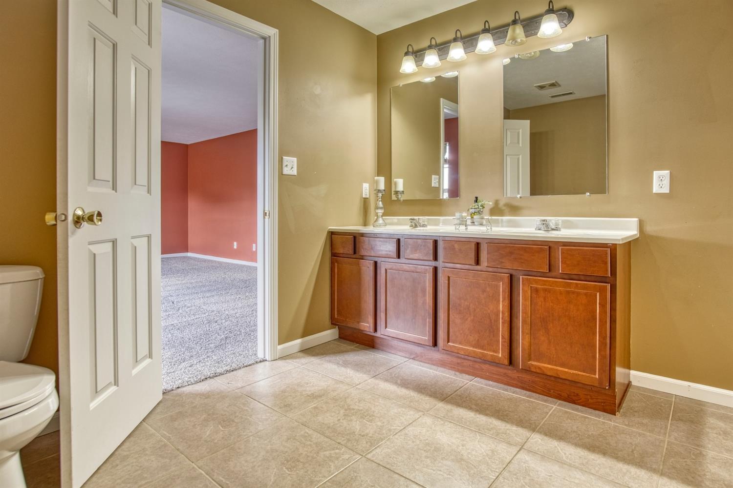 9512 Dewey Place Crown Point, IN 46307 - Photo 13 of 27 a spacious bathroom with a sink and a mirror