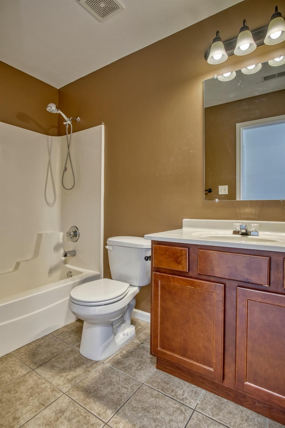 9512 Dewey Place Crown Point, IN 46307 - Photo 19 of 27 a bathroom with a sink a toilet and shower
