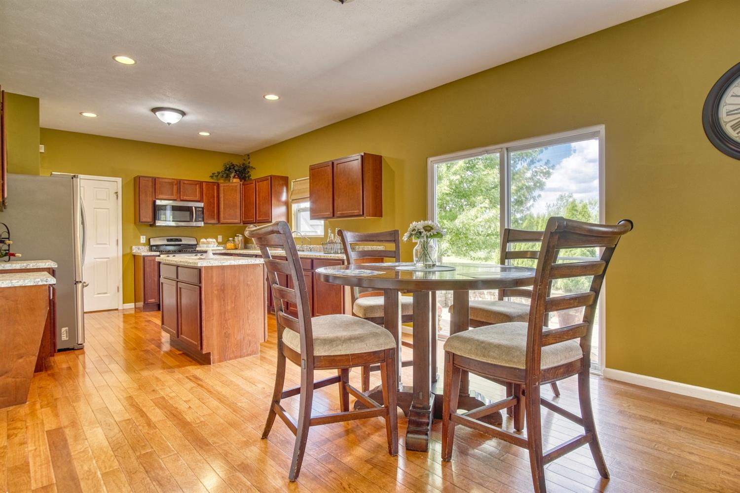 9512 Dewey Place Crown Point, IN 46307 - Photo 6 of 27 a dining room with stainless steel appliances furniture a window and kitchen view