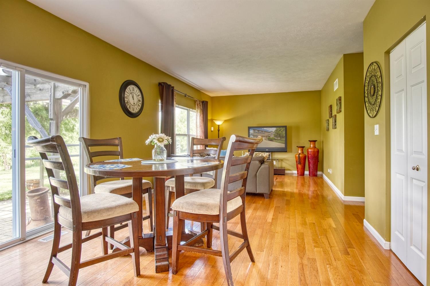 9512 Dewey Place Crown Point, IN 46307 - Photo 7 of 27 a view of a dining room with furniture and wooden floor