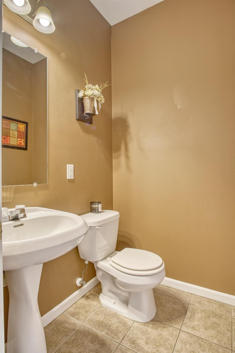 9512 Dewey Place Crown Point, IN 46307 - Photo 9 of 27 a bathroom with a toilet a sink and mirror