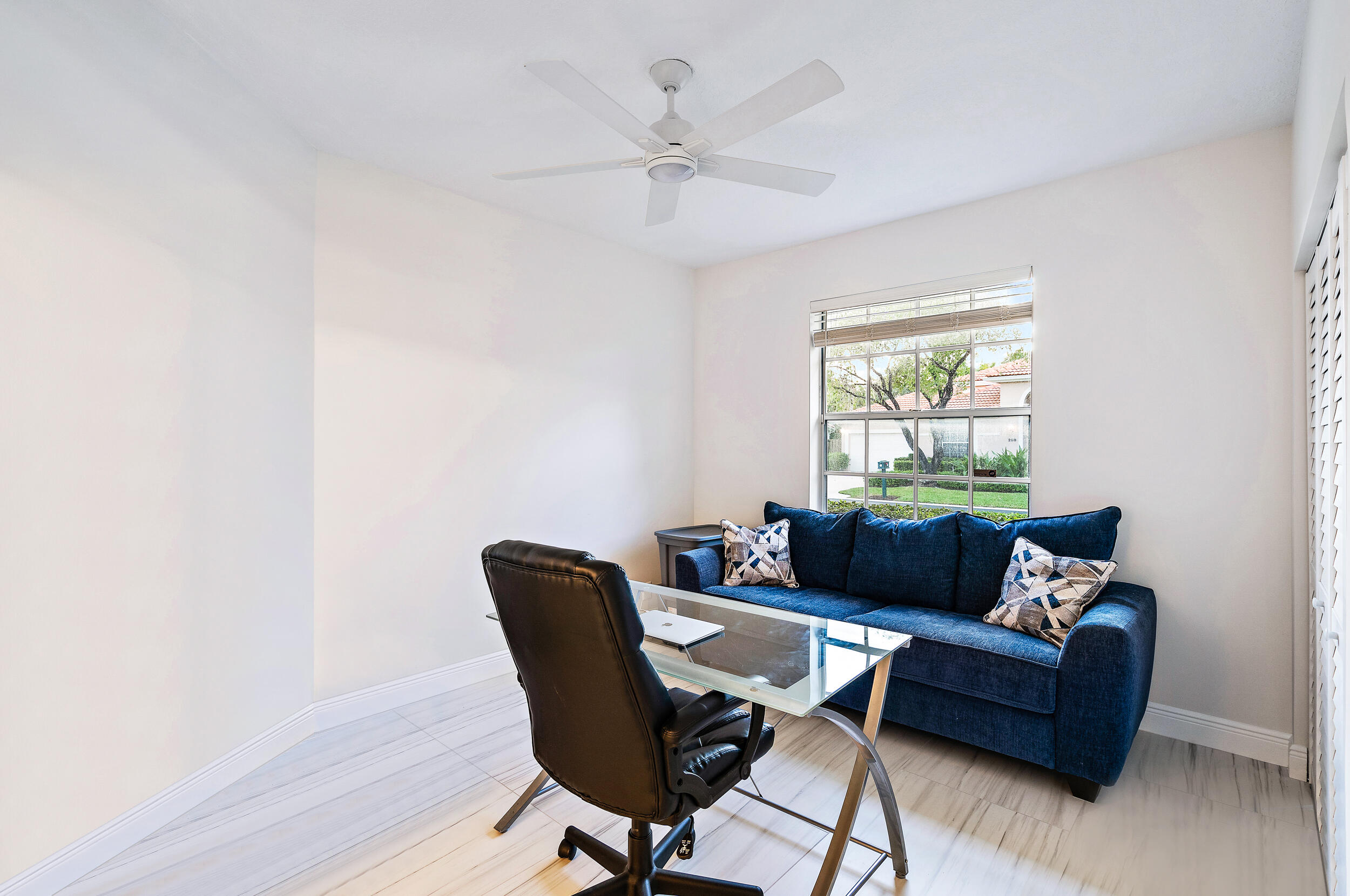 207 Eagleton Estates Boulevard Palm Beach Gardens, FL 33418 - Photo 19 of 33 a living room with furniture and a window