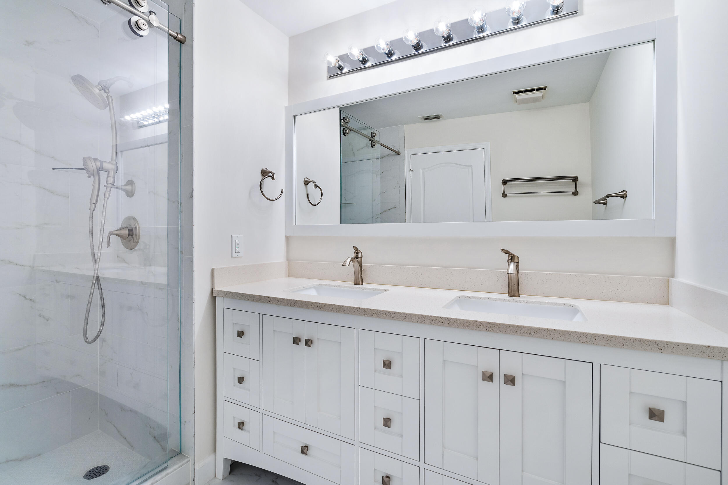 207 Eagleton Estates Boulevard Palm Beach Gardens, FL 33418 - Photo 22 of 33 a bathroom with a shower sink and mirror