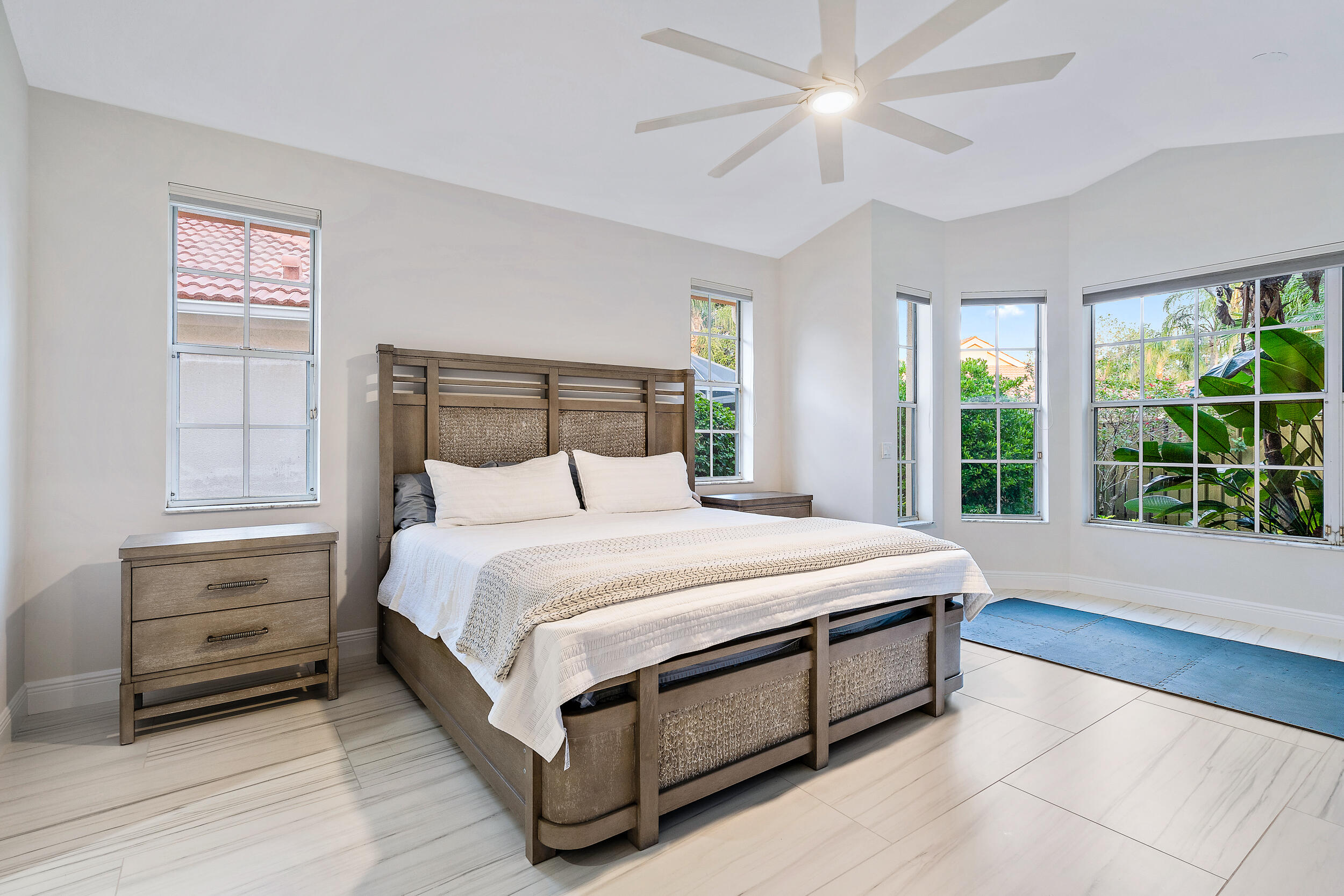 207 Eagleton Estates Boulevard Palm Beach Gardens, FL 33418 - Photo 7 of 33 a bed sitting in a bedroom next to a window