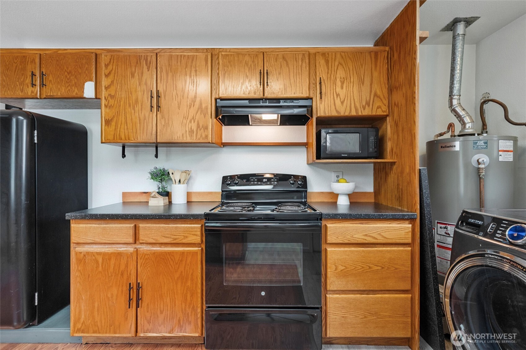 1264 Birch Bay Lynden Road Lynden, WA 98264 - Photo 6 of 38 a kitchen with kitchen island granite countertop a stove top oven microwave and cabinets