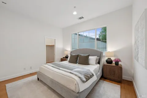 a bedroom with a bed a lamp and window