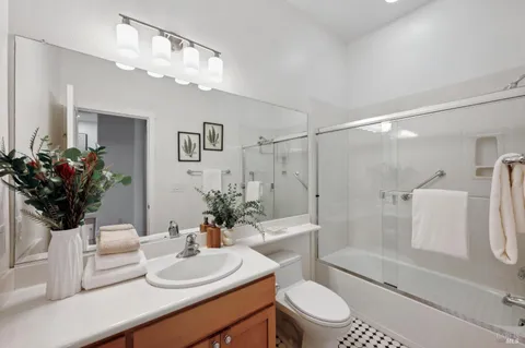 a bathroom with a sink a toilet and shower