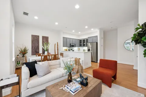 a living room with furniture kitchen and a table