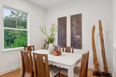 a view of a dining room with furniture window and wooden floor
