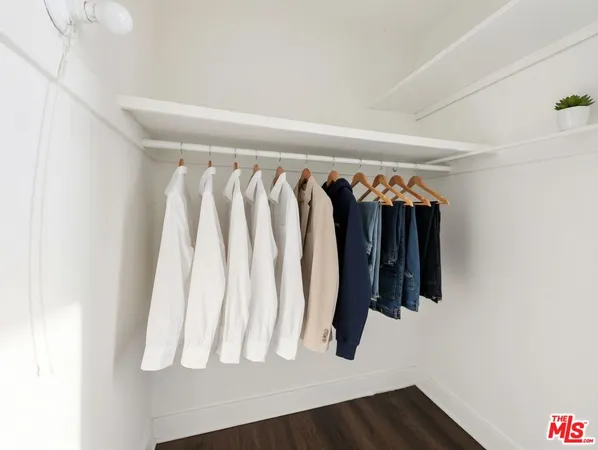 a view of walk in closet with clothes