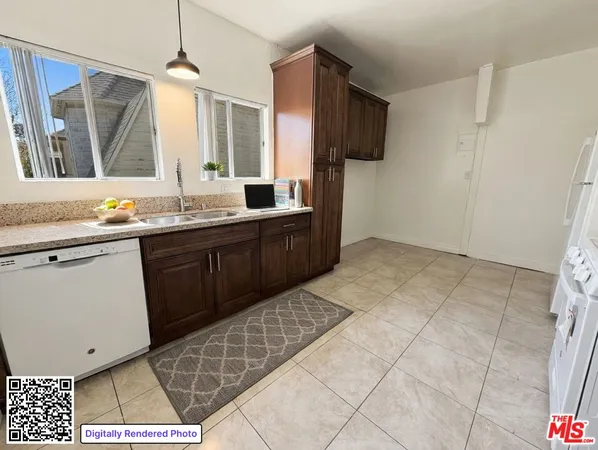 a kitchen with stainless steel appliances a sink a stove a refrigerator cabinets and a dining table