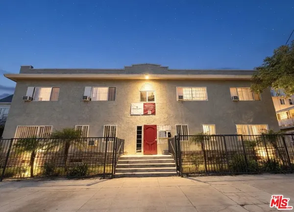 a view of a brick house with many windows