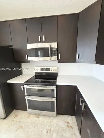 a stove top oven sitting inside of a kitchen