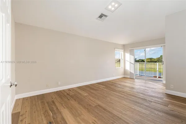 wooden floor in an empty room with a window