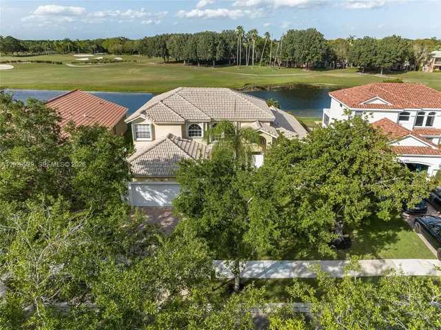an aerial view of a house with lake view