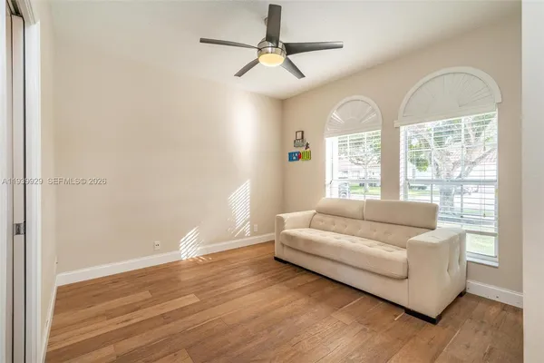 a living room with furniture and wooden floor