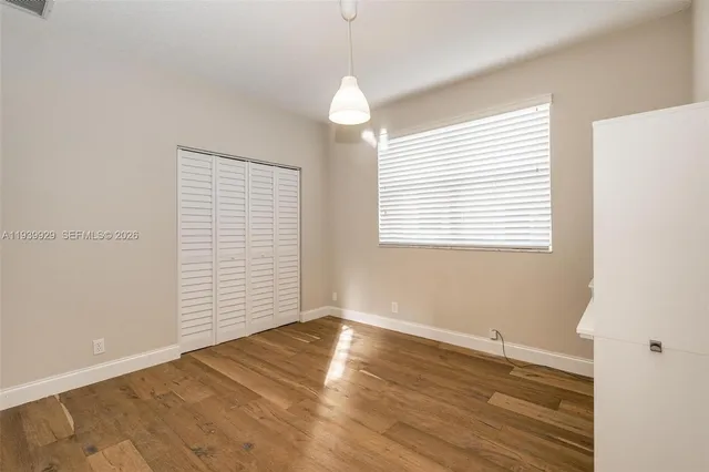 a view of swimming pool with a table and chairs under an umbrella
