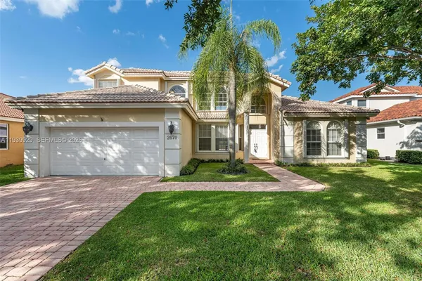 a front view of a house with a yard and garage
