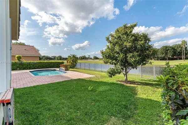 a view of a house with a yard and tree s
