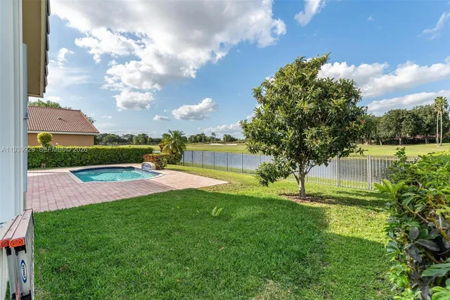 a view of a house with a yard and tree s