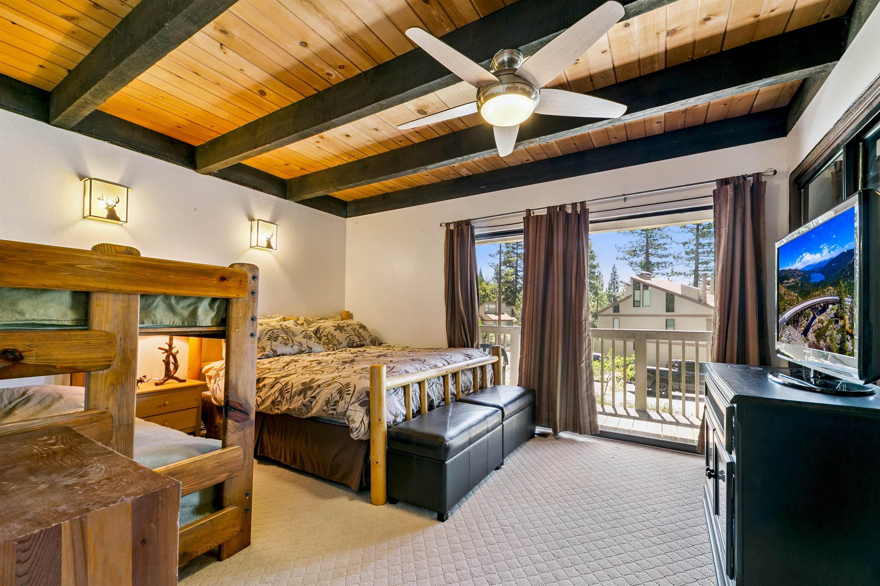 1001 Commonwealth Drive, Unit 106 Kings Beach, CA 96143 - Photo 12 of 27 a bed room with furniture and a flat screen tv