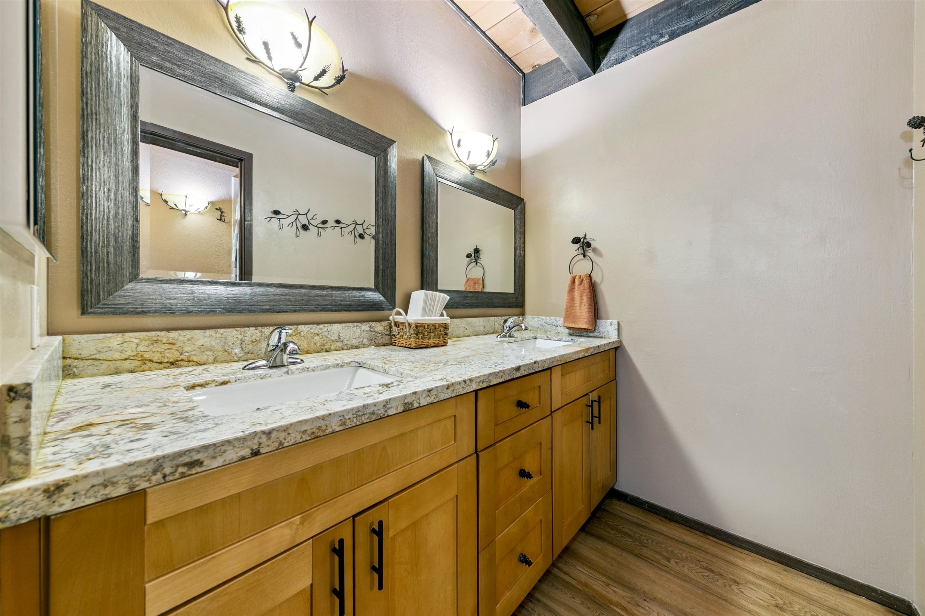 1001 Commonwealth Drive, Unit 106 Kings Beach, CA 96143 - Photo 16 of 27 a bathroom with a granite countertop sink vanity and a mirror