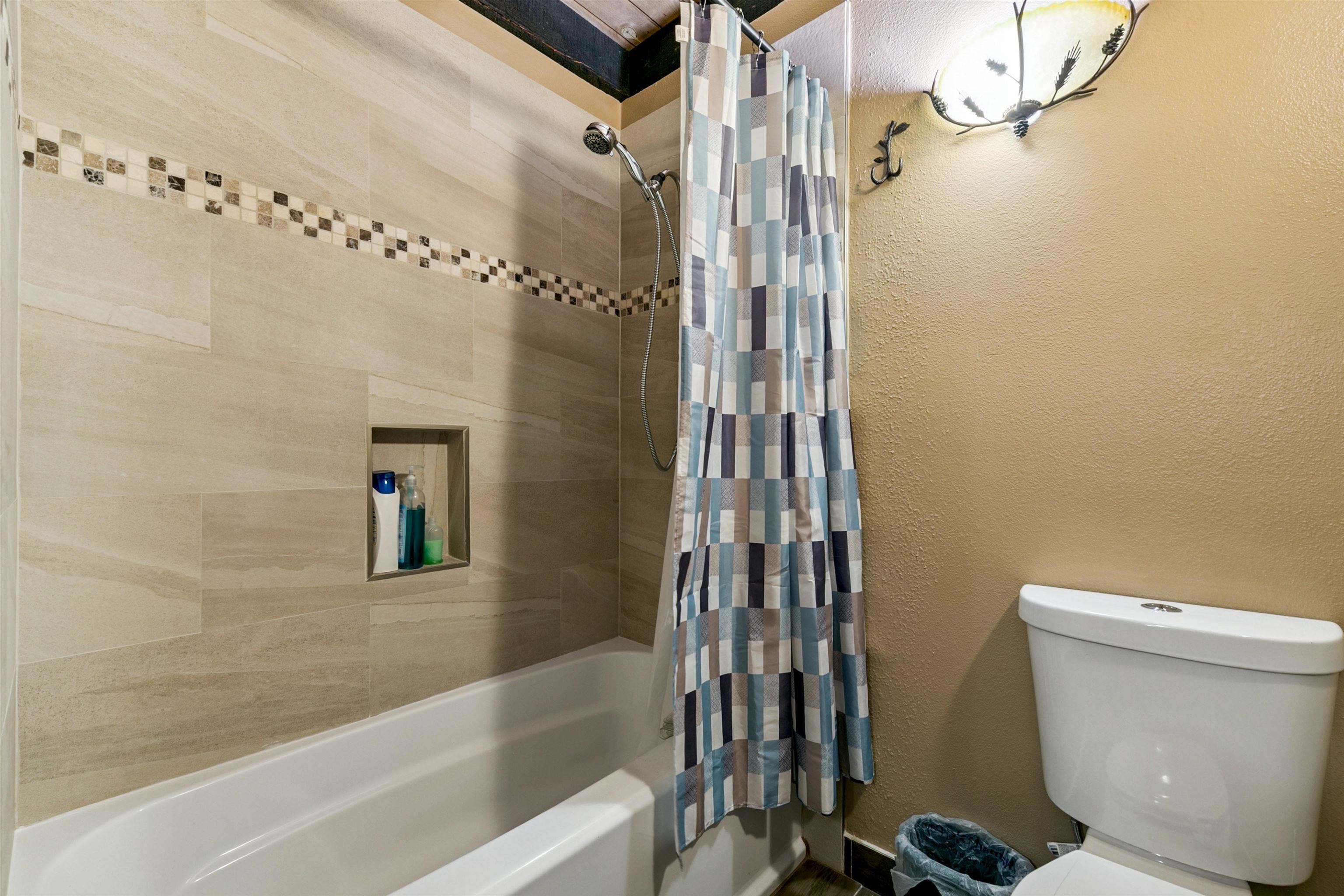 1001 Commonwealth Drive, Unit 106 Kings Beach, CA 96143 - Photo 18 of 27 a bathroom with a shower a toilet and a sink