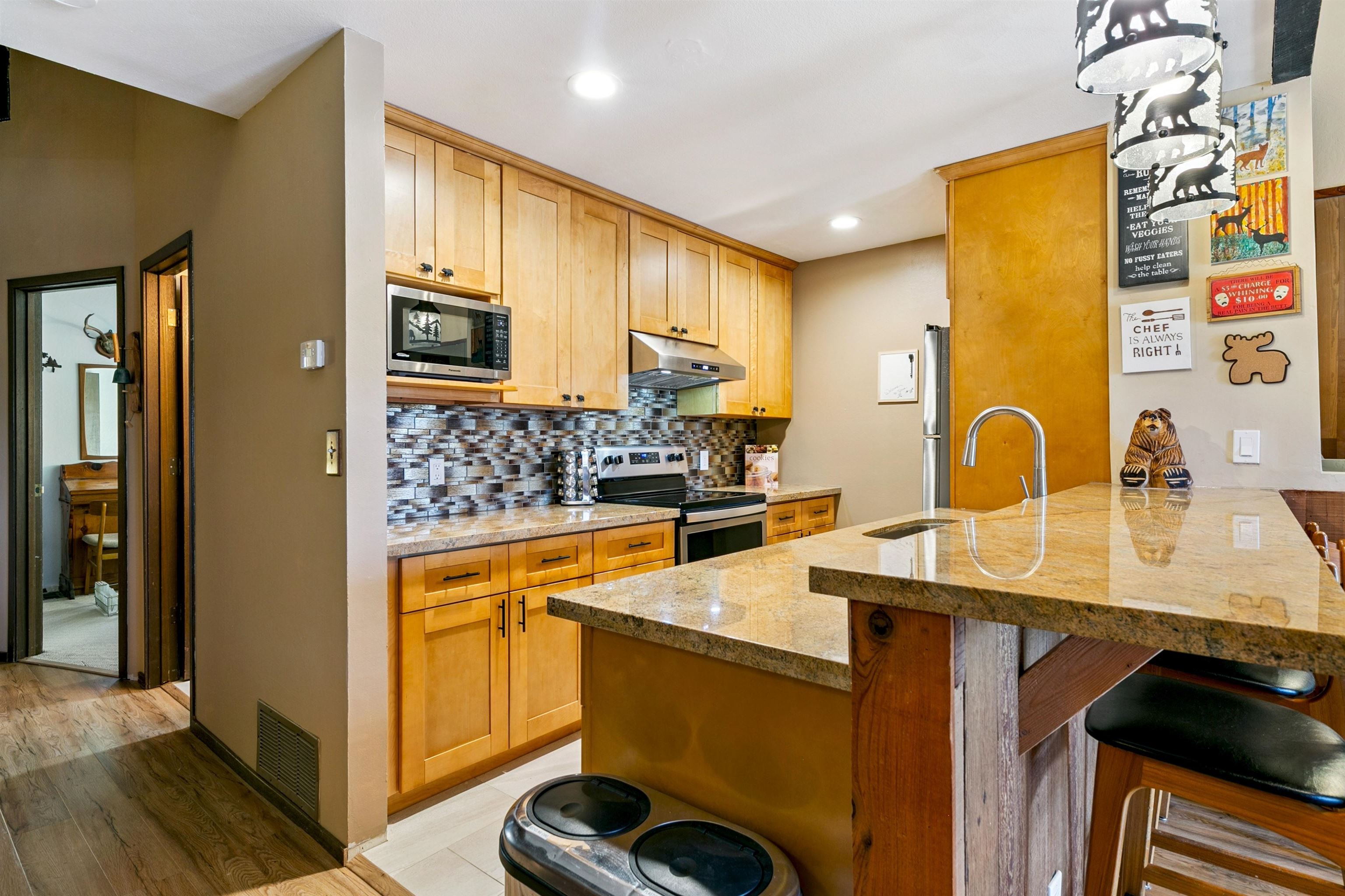 1001 Commonwealth Drive, Unit 106 Kings Beach, CA 96143 - Photo 2 of 27 a kitchen with stainless steel appliances granite countertop a sink stove and refrigerator