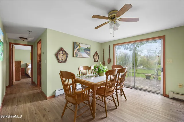 a dining room with furniture a chandelier and wooden floor