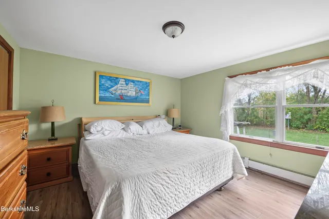 a bedroom with a large bed and a large window