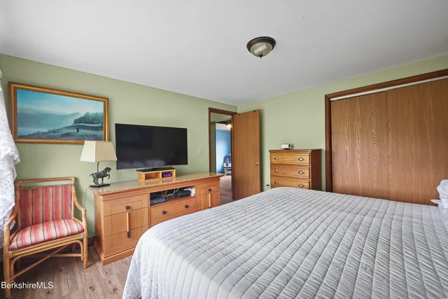 a bedroom with a bed and a flat screen tv