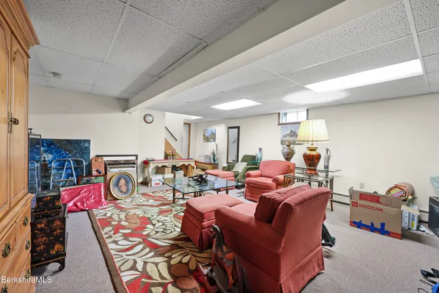 a living room with furniture a flat screen tv and a table