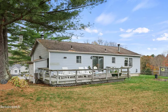 a view of a house with backyard porch and sitting area
