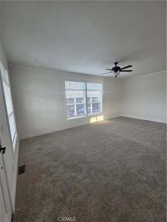 an empty room with a empty space and windows