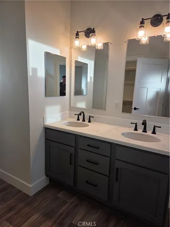 a bathroom with a double vanity sink and a mirror