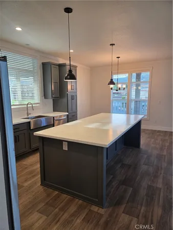 a kitchen with a sink cabinets and wooden floor